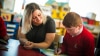 A teacher helping a primary school child